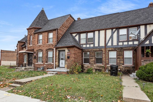 tudor house featuring a front yard