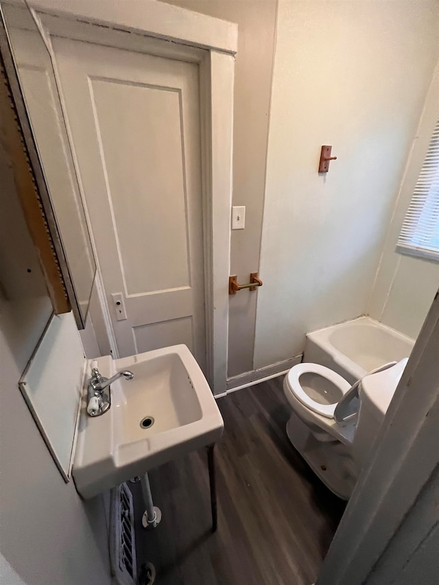 bathroom featuring hardwood / wood-style flooring, toilet, and sink