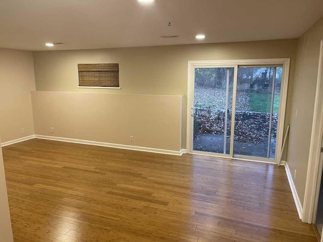 spare room with hardwood / wood-style flooring