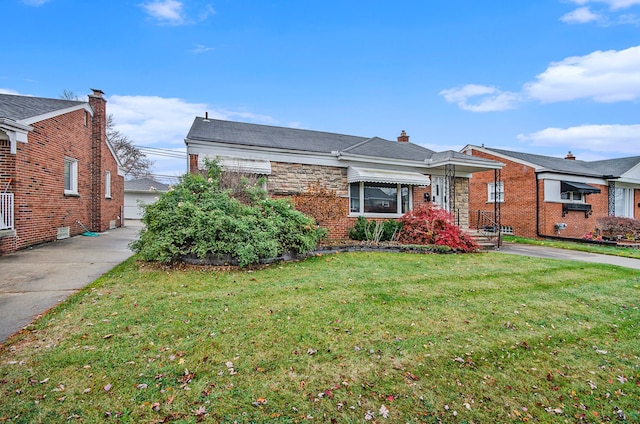 view of front of home with a front lawn and brick siding