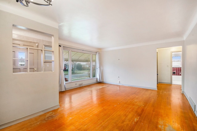 empty room with hardwood / wood-style flooring