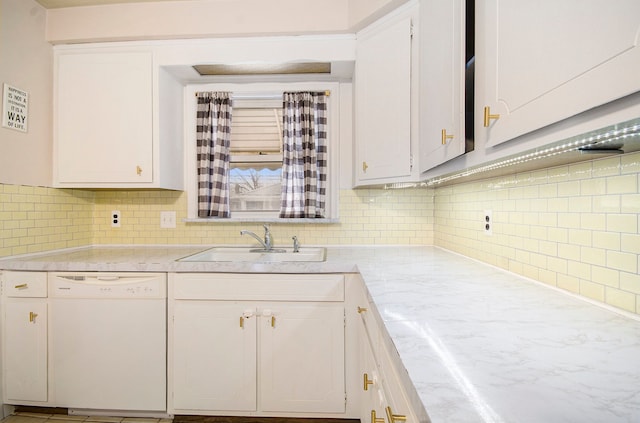 kitchen featuring a sink, tasteful backsplash, white cabinetry, and dishwasher