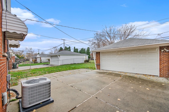 garage featuring a yard and central air condition unit