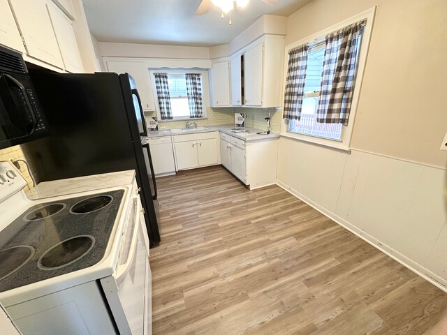 kitchen featuring white cabinetry, sink, white electric range oven, ceiling fan, and light wood-type flooring