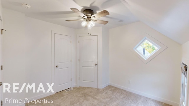 bonus room with ceiling fan, lofted ceiling, and light carpet