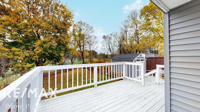 wooden deck with a storage shed