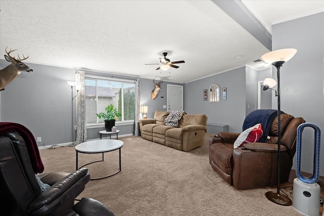 living room with light carpet, ceiling fan, a textured ceiling, and ornamental molding