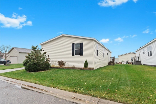 view of side of home with a yard