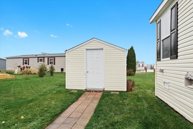 view of outbuilding with a yard