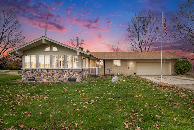 ranch-style house with a yard and a garage