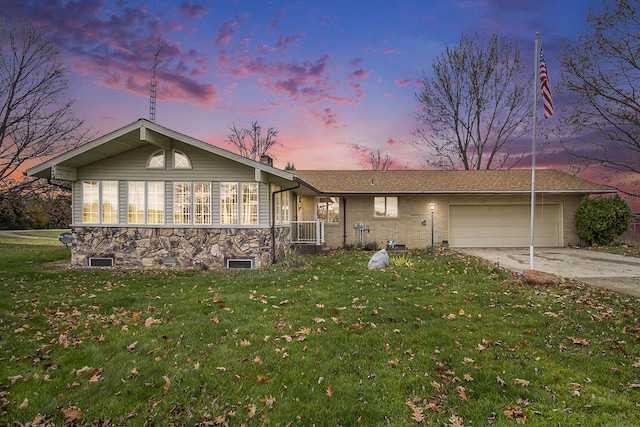 7349 E Main St, Eau Claire, MI 49111 - ranch-style house featuring concrete driveway, a yard, an attached garage, and stone siding
