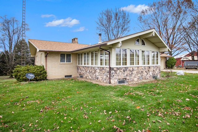 view of side of home with a lawn