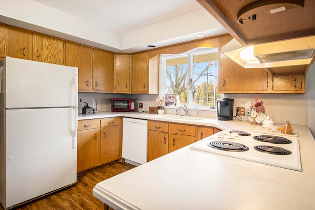 kitchen with sink, white appliances, dark wood-type flooring, and extractor fan