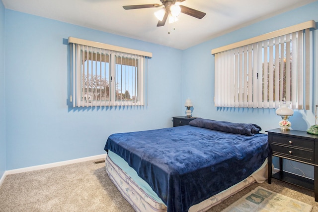 bedroom featuring ceiling fan and light carpet