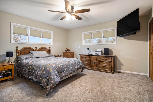 carpeted bedroom with ceiling fan and multiple windows