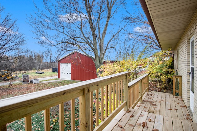 wooden deck with an outbuilding and a garage