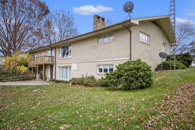7349 E Main St, Eau Claire, MI 49111 - rear view of property featuring a chimney and a lawn