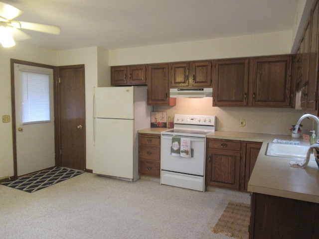 kitchen with ceiling fan, sink, light colored carpet, and white appliances