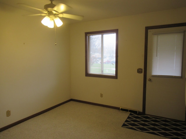 spare room with light colored carpet and ceiling fan