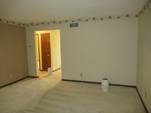 spare room with light colored carpet