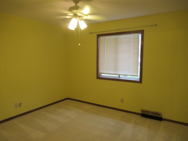 unfurnished room featuring ceiling fan and light carpet