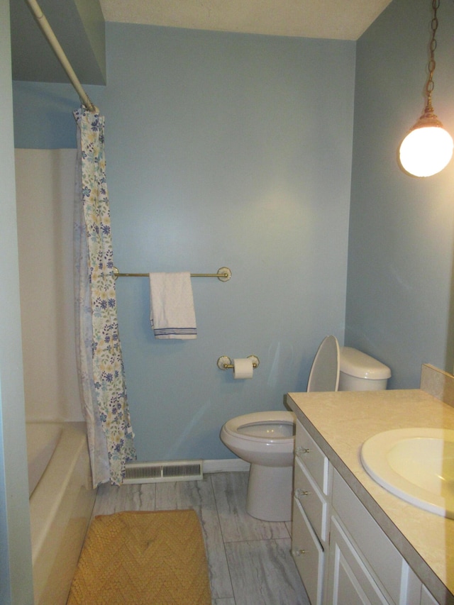 full bathroom featuring vanity, toilet, and shower / tub combo with curtain