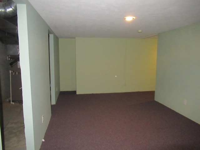 basement featuring dark carpet