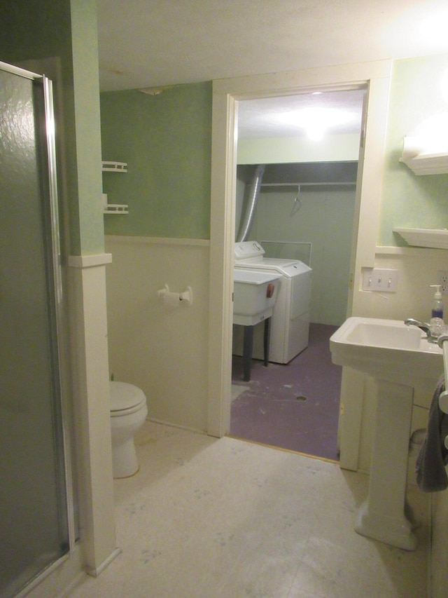 bathroom featuring toilet, walk in shower, and sink