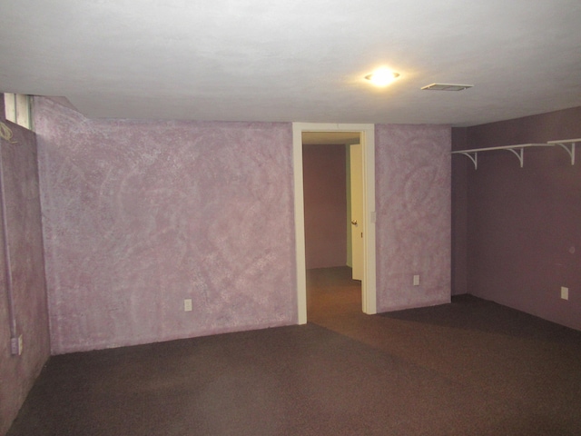 interior space featuring dark colored carpet