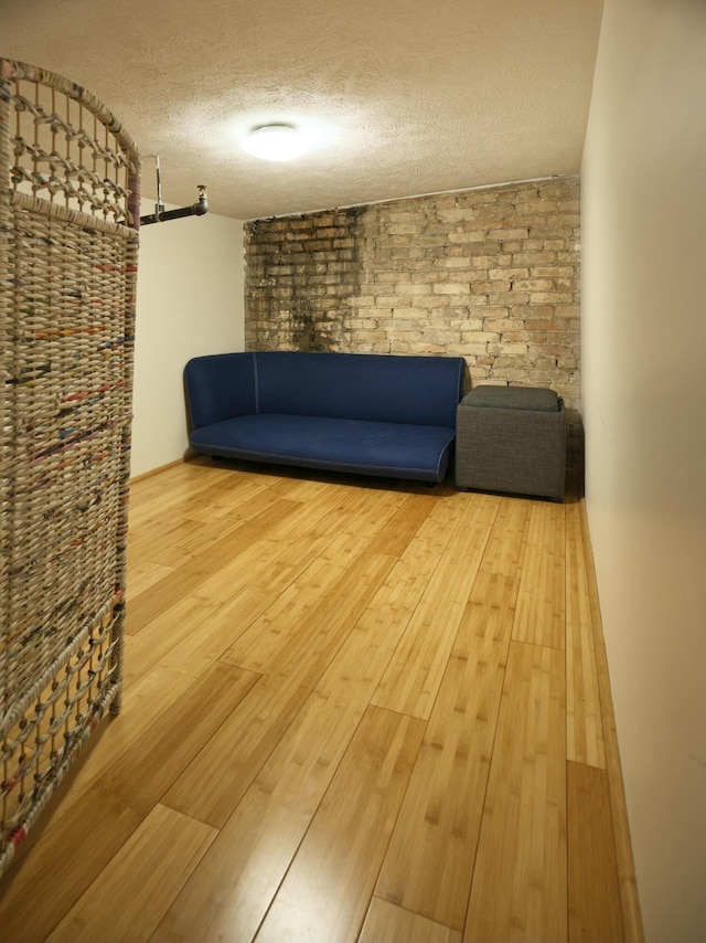 unfurnished living room with hardwood / wood-style floors and a textured ceiling