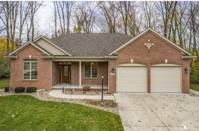 ranch-style house featuring a garage, brick siding, a front yard, and covered porch