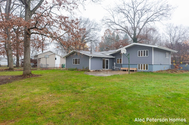 back of property with a lawn and a patio