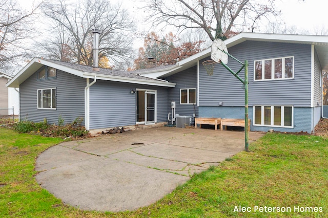 back of property featuring cooling unit, a patio area, and a lawn