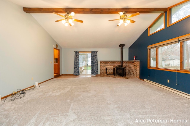 unfurnished living room featuring beamed ceiling, ceiling fan, and a wood stove