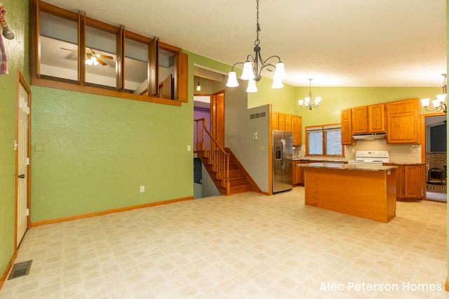 kitchen with stainless steel fridge, white range oven, pendant lighting, a center island, and lofted ceiling