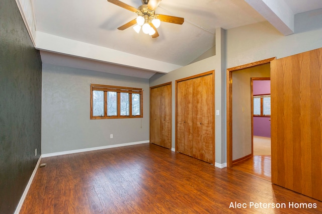 unfurnished bedroom featuring ceiling fan, dark hardwood / wood-style floors, and lofted ceiling