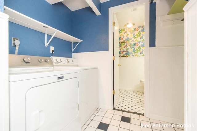 laundry room with light tile patterned floors and separate washer and dryer