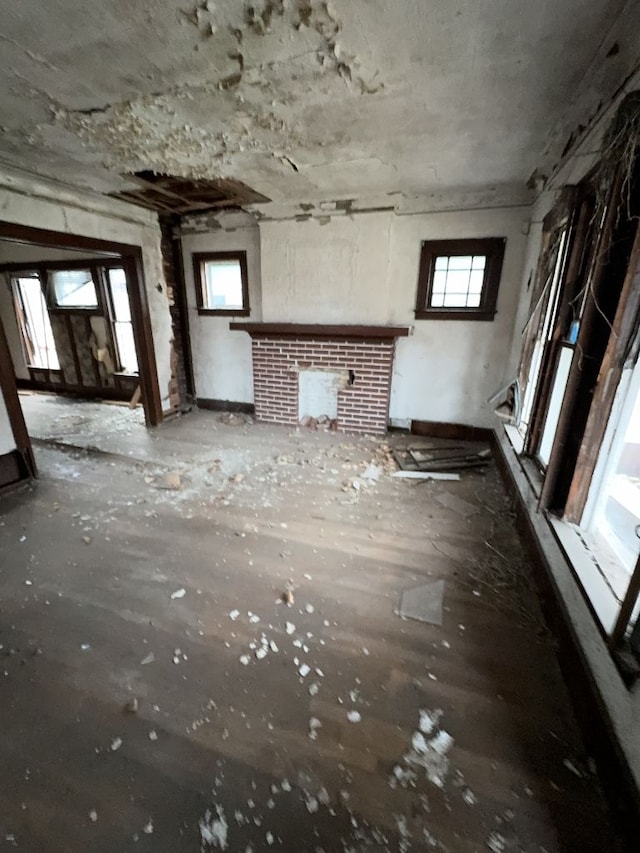 miscellaneous room with a healthy amount of sunlight and a brick fireplace