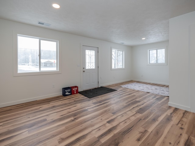 foyer featuring a textured ceiling and hardwood / wood-style flooring