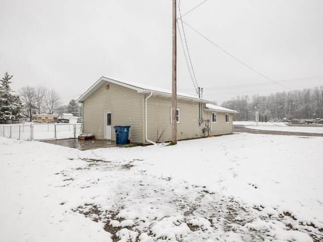 view of snow covered rear of property