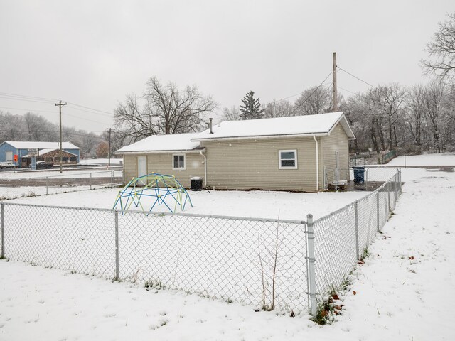 snow covered property featuring central AC unit