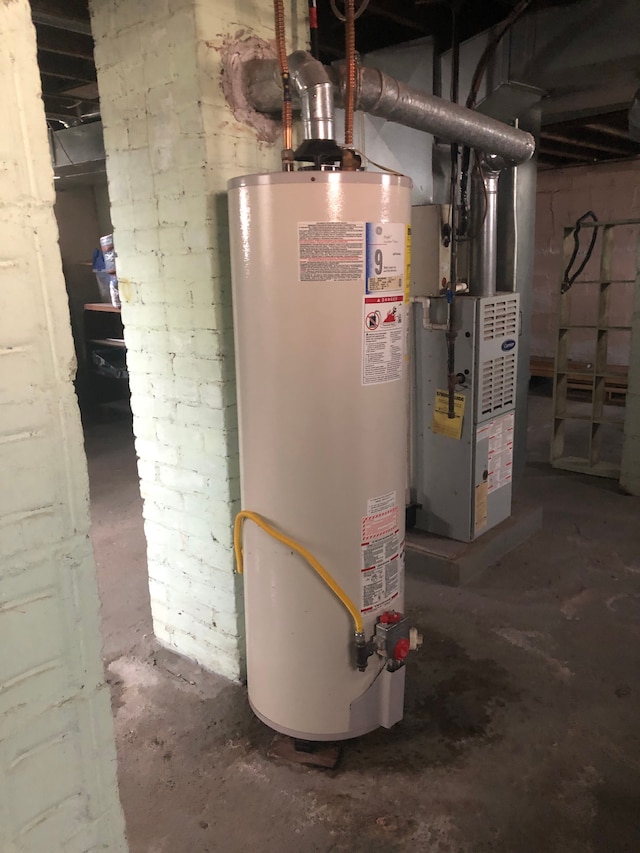 utility room featuring water heater