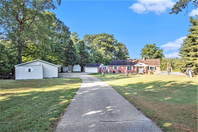 1806 Bond St, Niles, MI 49120 - single story home with an outdoor structure, a front lawn, driveway, and a chimney