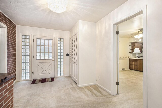 1806 Bond St, Niles, MI 49120 - carpeted entryway featuring a chandelier, ceiling fan, baseboards, and brick wall