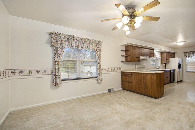 1806 Bond St, Niles, MI 49120 - kitchen featuring open shelves, brown cabinetry, a peninsula, range with electric cooktop, and white fridge with ice dispenser