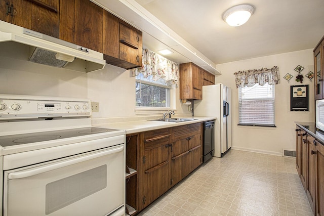 1806 Bond St, Niles, MI 49120 - kitchen with white electric stove, a sink, black dishwasher, under cabinet range hood, and plenty of natural light