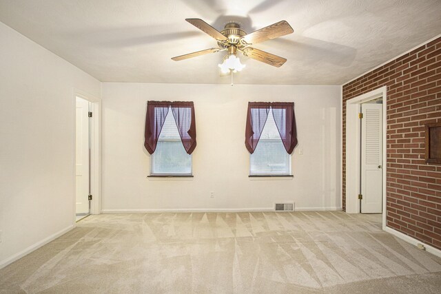 1806 Bond St, Niles, MI 49120 - carpeted empty room featuring healthy amount of natural light, a ceiling fan, baseboards, and brick wall