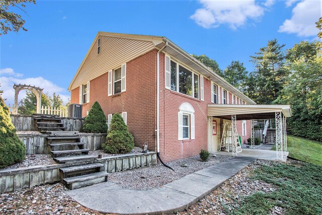 1806 Bond St, Niles, MI 49120 - view of side of home with stairway, brick siding, and a patio