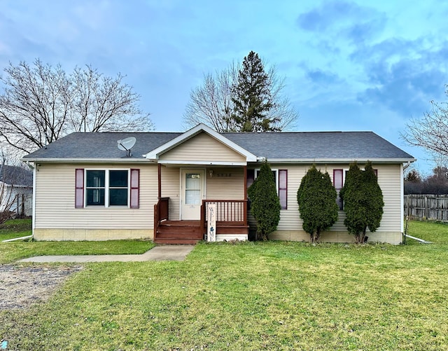 view of front of home featuring covered porch and a front lawn