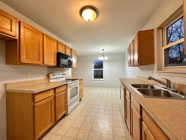 kitchen featuring sink, hanging light fixtures, an inviting chandelier, stainless steel dishwasher, and white range with electric stovetop